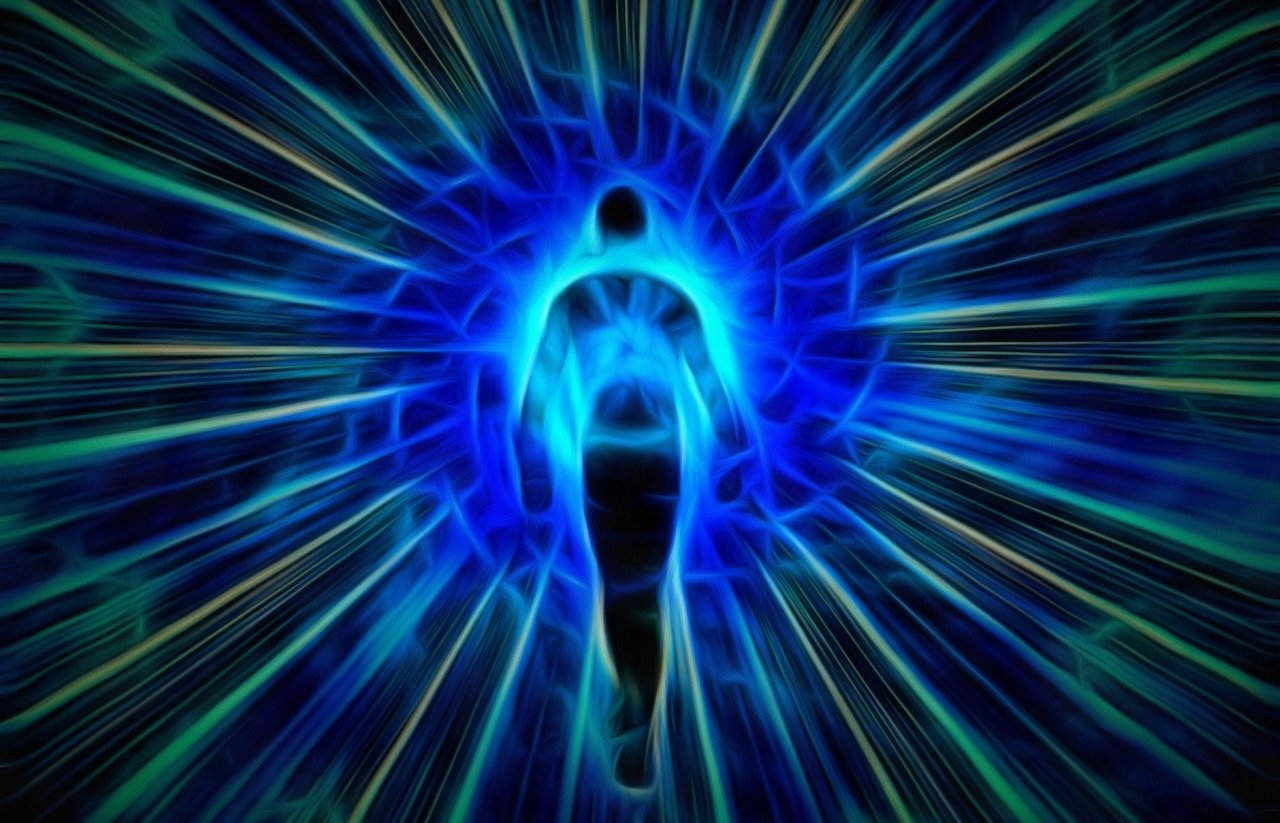 A spiritual-style abstract human form with colored rays fanning out from it